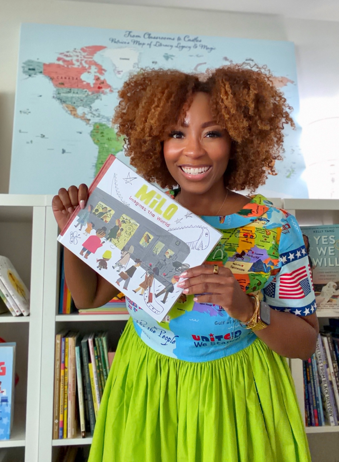 Patrice Jenkins holding Milo Imagines the World in her map dress